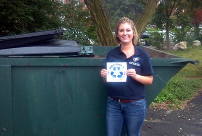 Image of Staphanie Gorman in front of recycling dumpster