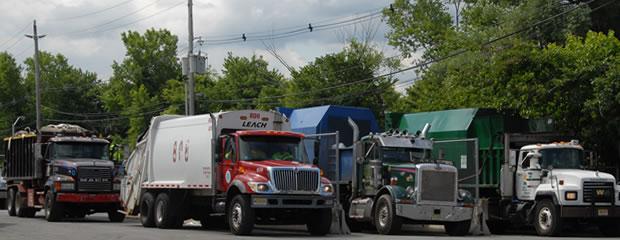 Image of garbage trucks in line